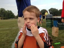 Melissa’s son eating a donut after soccer