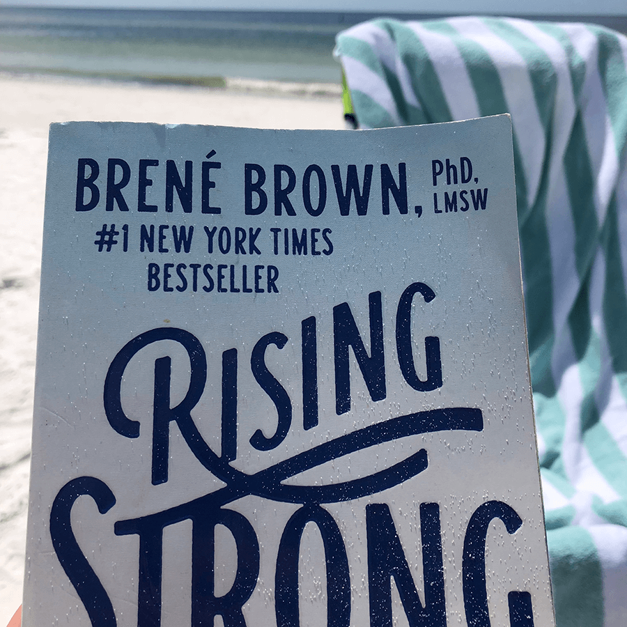 Cover of Rising String, by Brene Brown, on beach